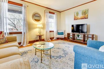 Cincinnati apartment for rent - A living room with a glass table and a television.