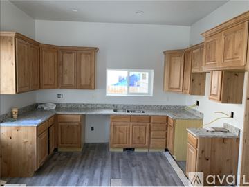 Heber City house for rent - A kitchen with wooden cabinets and a marble countertop.