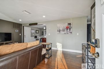 Holiday house for rent - A living room with a brown couch and a coffee table.