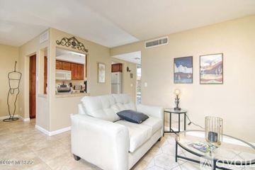 Tucson condo for rent - A living room with a white couch and a glass coffee table.