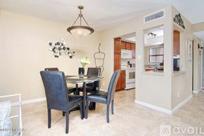 Tucson condo for rent - A dining room with a table and chairs.