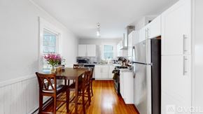 Somerville apartment for rent - A kitchen with white cabinets and a wooden table.