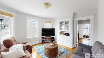 Somerville apartment for rent - A living room with a brown chair and a grey sofa.
