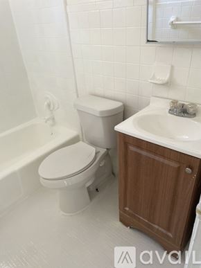 Jacksonville apartment for rent - A white toilet sits next to a white sink in a bathroom.