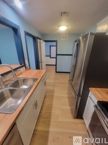 Wichita house for rent - A kitchen with a sink and refrigerator.