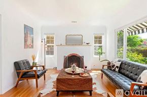 Santa Barbara house for rent - A living room with a fireplace, a couch, a chair, and a coffee table.