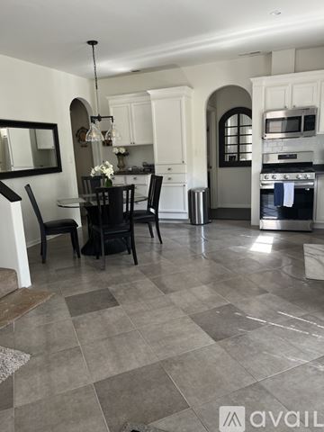 Los Angeles house for rent - A kitchen with a dining table and chairs.