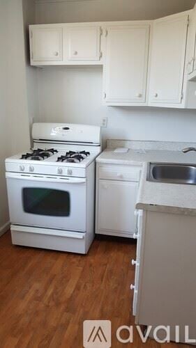 Wheeling apartment for rent - A kitchen with a white stove and a white dishwasher.