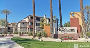 Phoenix apartment for rent - The Hawthorne Condominiums is a building surrounded by palm trees.