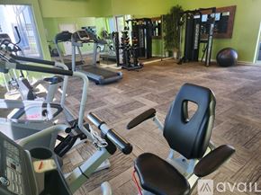 Phoenix apartment for rent - A gym with a variety of equipment including treadmills, weights, and exercise balls.