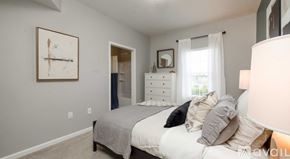 Sunbury apartment for rent - A bedroom with a bed, dresser, and a painting on the wall.