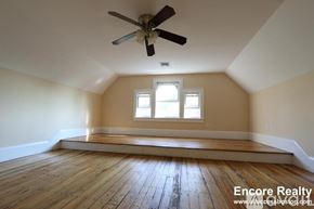 Boston apartment for rent - A room with a ceiling fan and wooden floors.