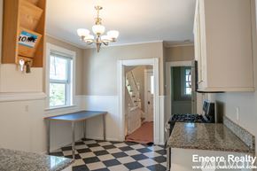 Boston apartment for rent - A kitchen with a checkered floor and a chandelier.
