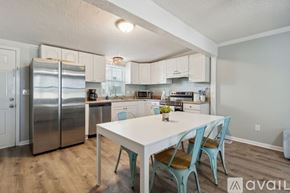 Fernandina Beach townhouse for rent - A kitchen with a table and chairs in front of it.