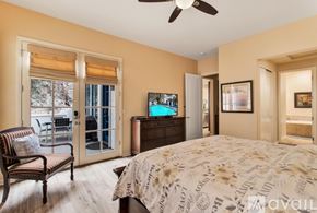 La Quinta house for rent - A bedroom with a large bed and a chair.