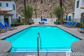 La Quinta house for rent - A pool surrounded by chairs and a mountain in the background.