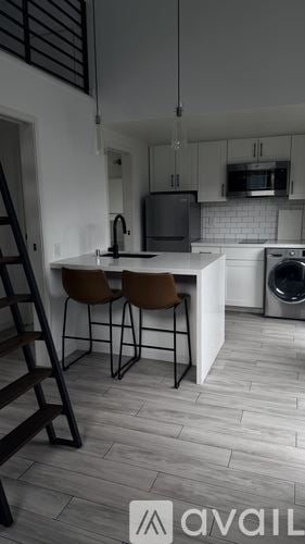 Oakland house for rent - A kitchen with a washing machine and a dining table with two chairs.