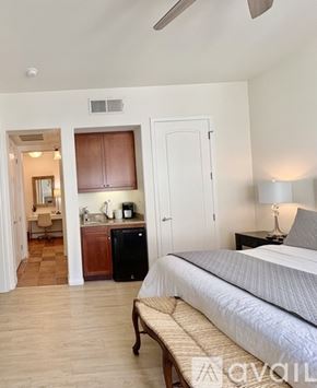 La Quinta townhouse for rent - A kitchen with brown cabinets and a black stove top oven.