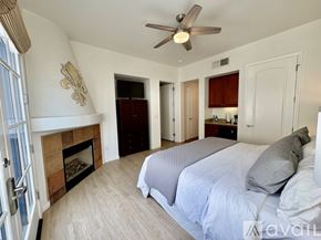La Quinta townhouse for rent - A bedroom with a large bed and a ceiling fan.