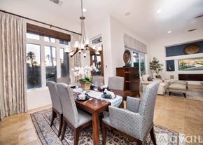 La Quinta house for rent - A dining room with a table set for two and a chandelier hanging from the ceiling.