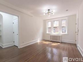 Merchantville apartment for rent - A room with wooden floors and a ceiling fan.