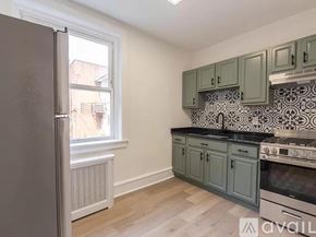 Merchantville apartment for rent - A kitchen with a refrigerator, oven, and cabinets.