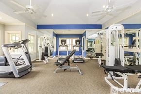 Irving apartment for rent - A spacious home gym with a variety of exercise equipment.