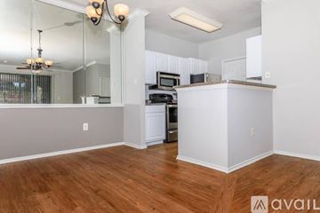 Irving apartment for rent - A kitchen with white cabinets and a wooden floor.