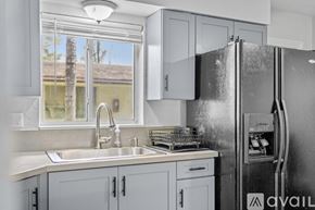 Fort Lauderdale apartment for rent - A kitchen with a black stove top oven and grey cabinets.
