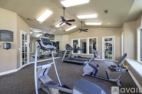 Fort Worth apartment for rent - A gym with treadmills, elliptical machines, and a fan.
