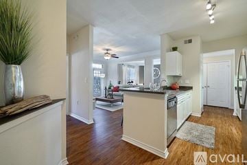 Fort Worth apartment for rent - A kitchen with white cabinets and a wooden floor.