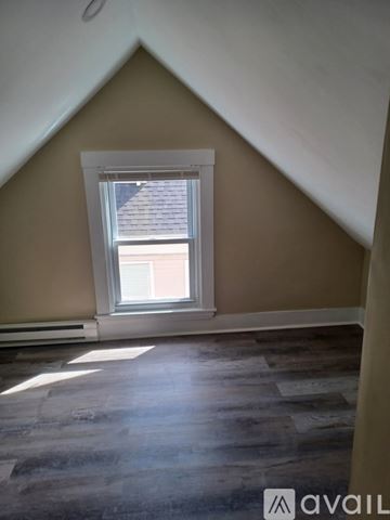 New Bedford apartment for rent - A room with a window and wooden flooring.