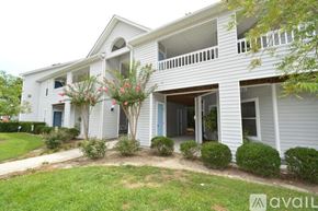 Greenville condo for rent - A white house with a balcony and a blue door.
