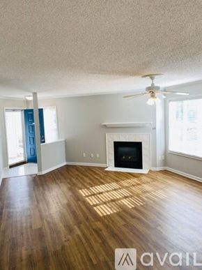 Greenville condo for rent - A room with a ceiling fan and wood flooring.