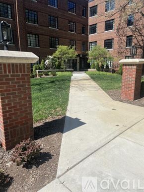 Highland Park apartment for rent - A brick building with a walkway in front.
