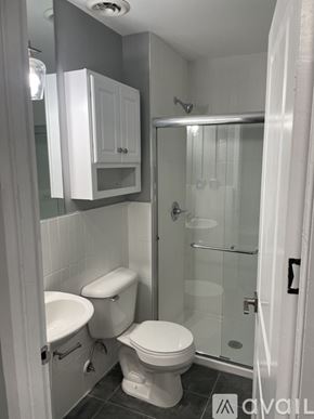 Highland Park apartment for rent - A bathroom with a toilet, sink, and shower.