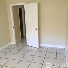 Lauderhill apartment for rent - A room with a white door and tiled floor.