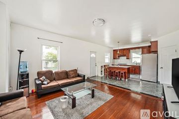Quincy apartment for rent - A living room with a brown sofa and a glass coffee table.