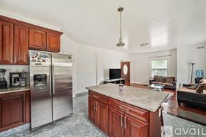 Quincy apartment for rent - A kitchen with wooden cabinets and a granite countertop.