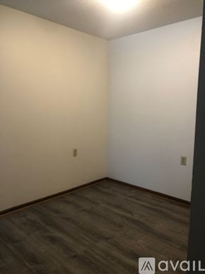 Mankato apartment for rent - A room with a wooden floor and white walls.