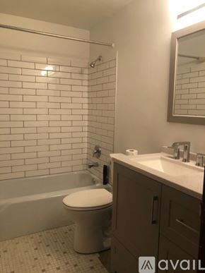 Mankato apartment for rent - A white toilet sits in a bathroom next to a sink.