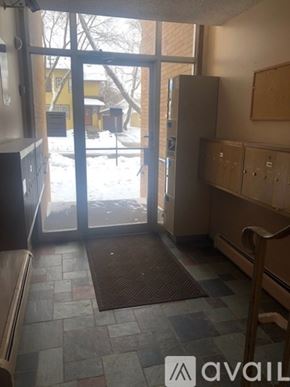 Mankato apartment for rent - A room with a brown mat on the floor and a refrigerator.