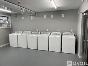 Highland Park apartment for rent - A row of white washing machines are lined up in a laundromat.