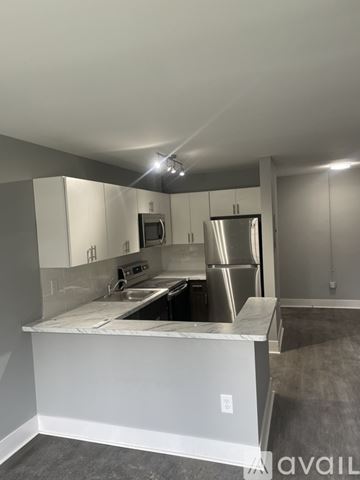 Highland Park apartment for rent - A kitchen with white cabinets and stainless steel appliances.