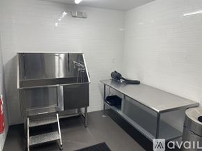 Highland Park apartment for rent - A clean, empty kitchen with stainless steel appliances and white tiled walls.