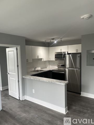 Highland Park apartment for rent - A kitchen with a white counter and stainless steel appliances.