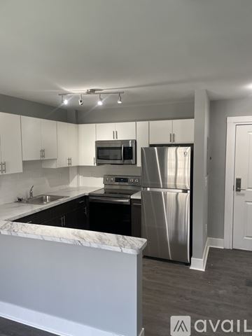 Highland Park apartment for rent - A kitchen with a marble countertop and stainless steel appliances.