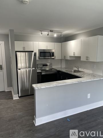 Highland Park apartment for rent - A kitchen with a white counter and stainless steel appliances.