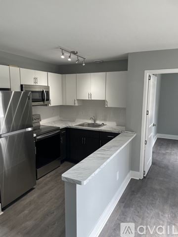 Highland Park apartment for rent - A kitchen with a refrigerator, microwave, and oven.