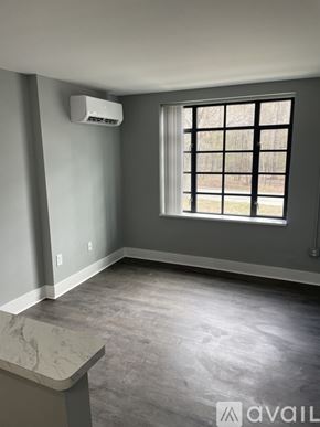 Highland Park apartment for rent - A room with a window and a wall-mounted air conditioner unit.